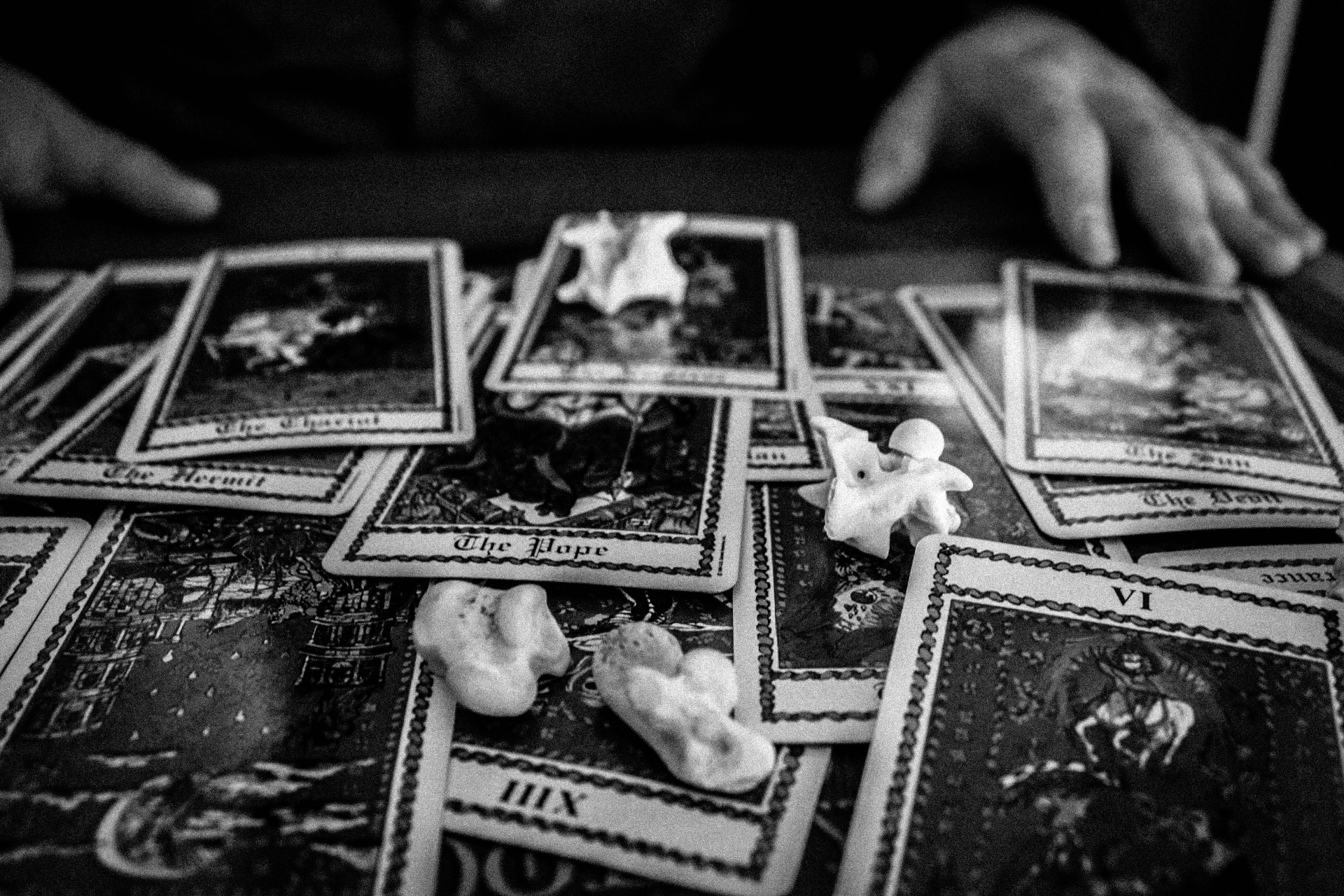 Mystic Dylan’s tarot cards and bones on a weathered reading cloth